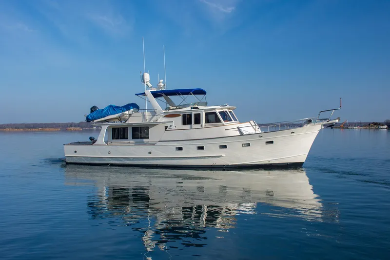 Slide: The Image of Fleming 55 yacht from 2000 on calm water under clear blue sky. - 49