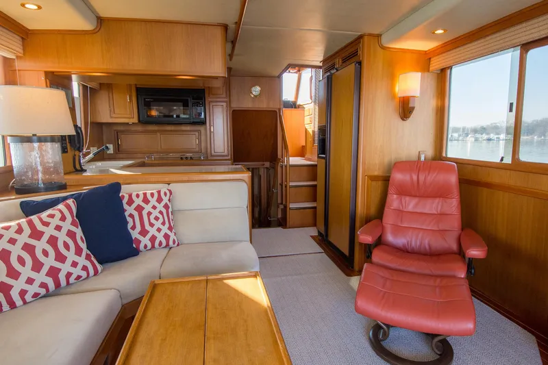 Slide: The Image of Luxurious interior of a 2000 Fleming 55 yacht with cozy seating and elegant wood finishes. - 5