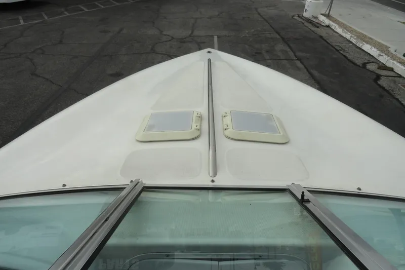 Slide: The Image of Bow view of a 1997 Caravelle Interceptor 232 boat, featuring dual hatches. - 14