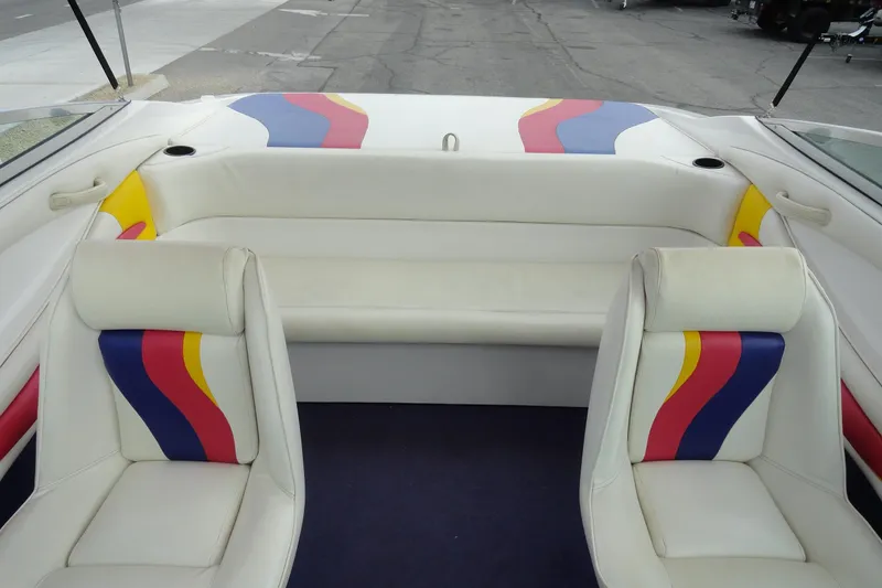 Slide: The Image of Interior of a 1997 Caravelle Interceptor 232 boat with colorful seating design. - 18