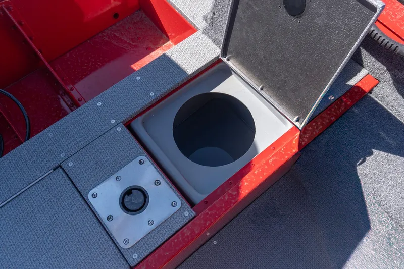 Slide: The Image of Open storage compartment on 2026 G3 Angler V21 F boat, featuring red and gray design. - 14