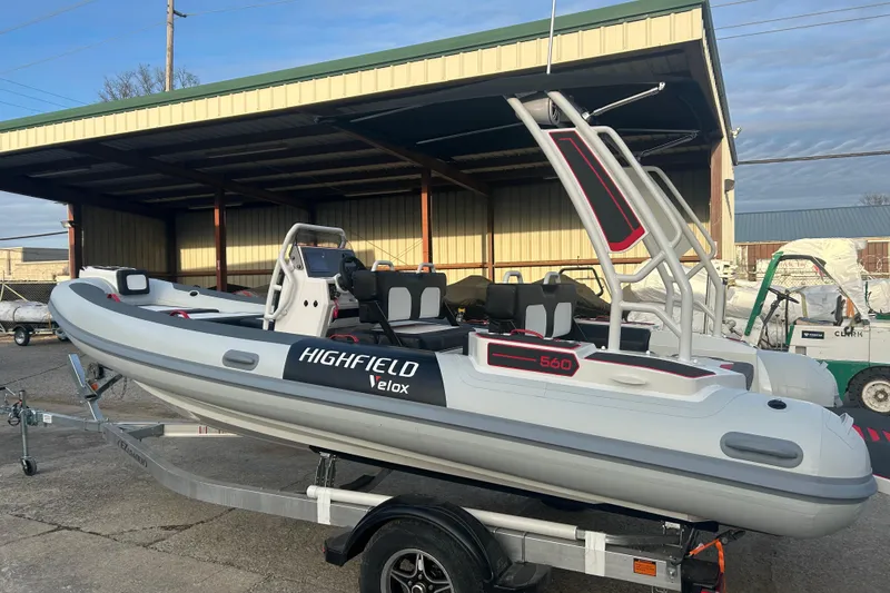 The Image of 2026 Highfield VELOX 560 boat on trailer, parked under a shelter. - 0