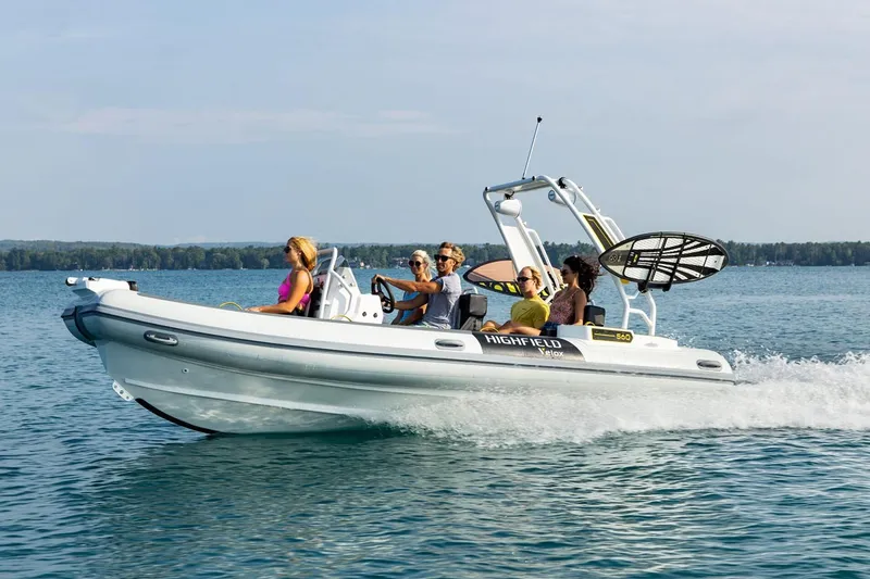 Slide: The Image of Manufacturer Provided Image: 2025 Highfield VELOX 560 boat cruising on a lake with passengers enjoying the ride. - 3