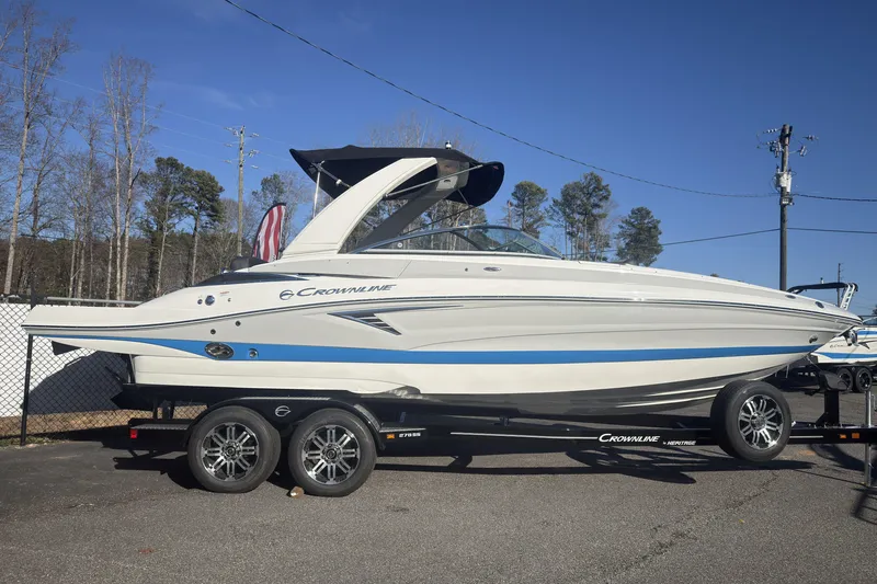The Image of 2026 Crownline 278 SS boat on trailer, parked outdoors under clear blue sky. - 0