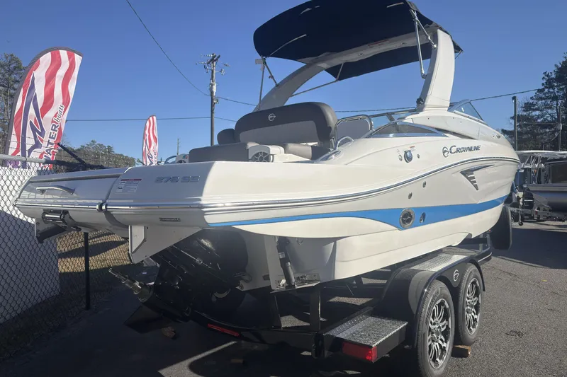 Slide: The Image of 2026 Crownline 278 SS boat on trailer, displayed outdoors under clear blue sky. - 6