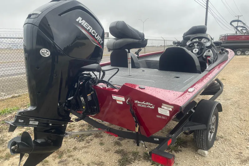 Slide: The Image of 2021 Tracker Pro Team 175 TXW boat with Mercury outboard motor, parked on a trailer. - 3