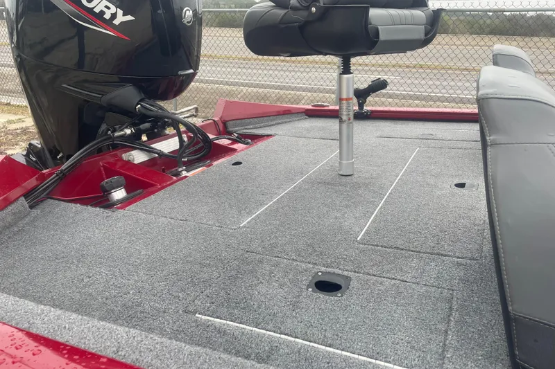 Slide: The Image of 2021 Tracker Pro Team 175 TXW boat deck with Mercury engine, gray carpet, and seating. - 6