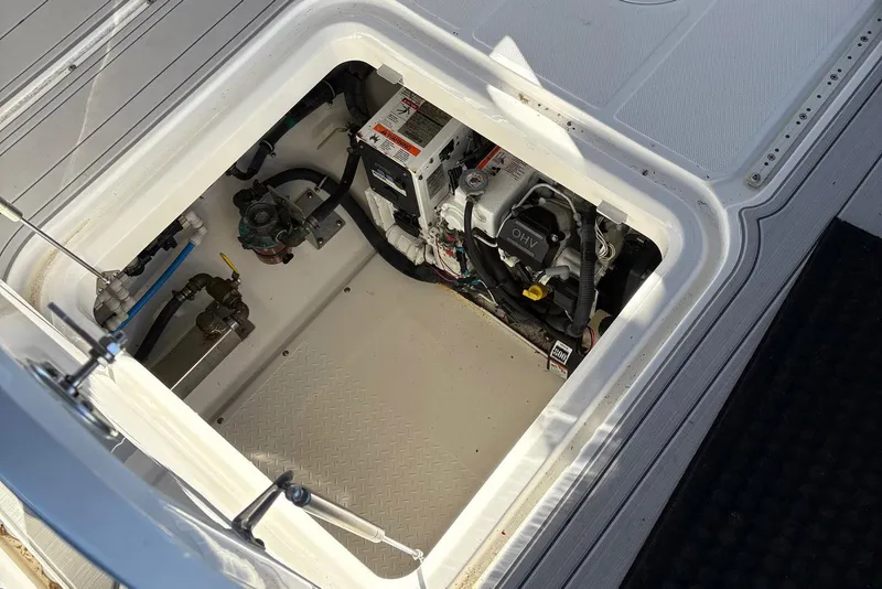 Slide: The Image of Engine compartment of a 2017 Everglades 350LX boat, showcasing mechanical components. - 11