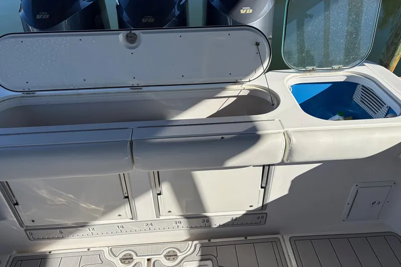 Slide: The Image of 2017 Everglades 350LX boat deck with storage compartments and V8 engines. - 13