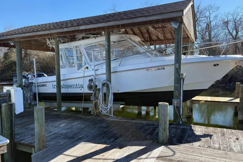 Slide: The Image of 2017 Everglades 350LX boat docked under a wooden shelter. - 16