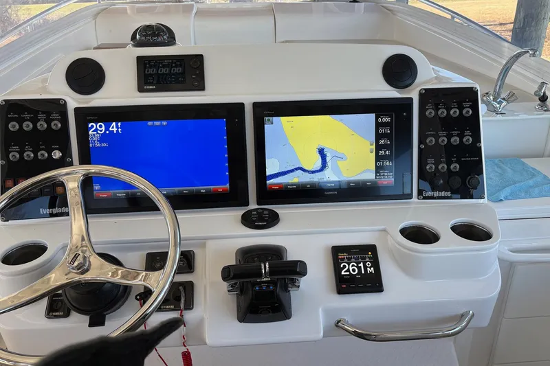 Slide: The Image of Control panel of a 2017 Everglades 350LX boat with navigation screens and steering wheel. - 6