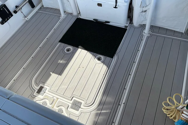 Slide: The Image of 2017 Everglades 350LX boat deck with non-slip flooring and storage compartments. - 9