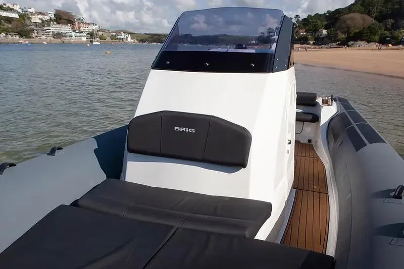 Slide: The Image of Manufacturer Provided Image: 2026 Brig Eagle 8 boat on calm water near a sandy beach. - 8