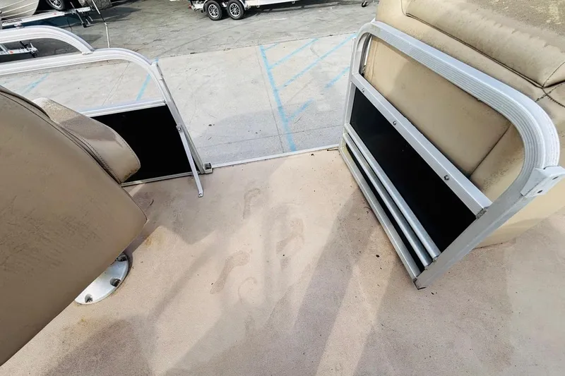 Slide: The Image of Interior of 2014 SunCatcher V322 RC pontoon boat with beige seating and flooring. - 12