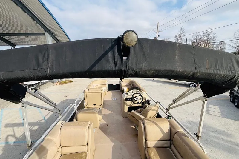 Slide: The Image of 2014 SunCatcher V322 RC pontoon boat with beige seating and black canopy. - 14