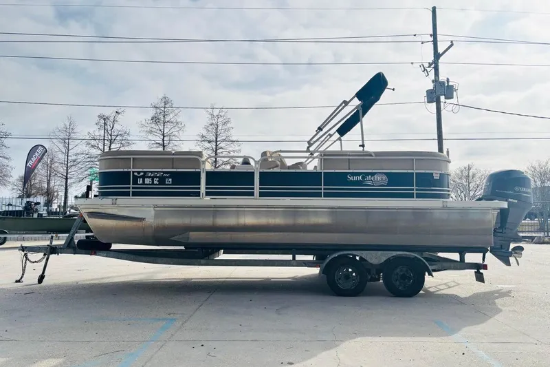 Slide: The Image of 2014 SunCatcher V322 RC pontoon boat on trailer, parked outdoors. - 7
