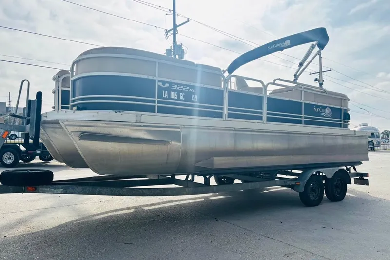 Slide: The Image of 2014 SunCatcher V322 RC pontoon boat on trailer, parked outdoors. - 8