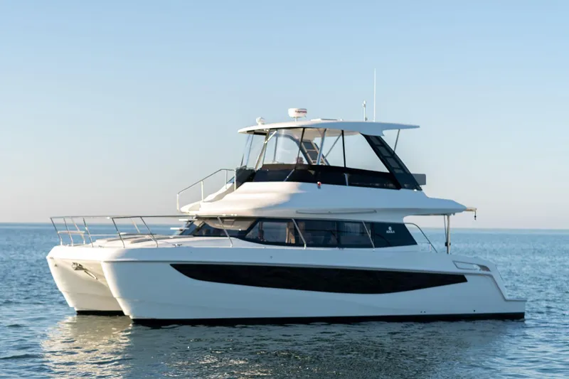 Slide: The Image of Manufacturer Provided Image: 2026 Aquila 42 Yacht cruising on calm waters under a clear sky. - 2