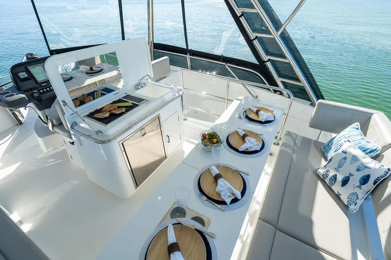 Slide: The Image of Manufacturer Provided Image: Luxurious 2026 Aquila 42 Yacht with elegant dining setup and ocean view. - 7