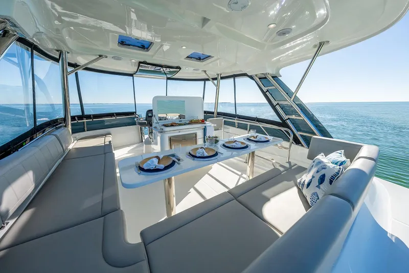 Slide: The Image of Manufacturer Provided Image: Luxurious 2026 Aquila 42 Yacht interior with elegant dining setup and ocean view. - 8