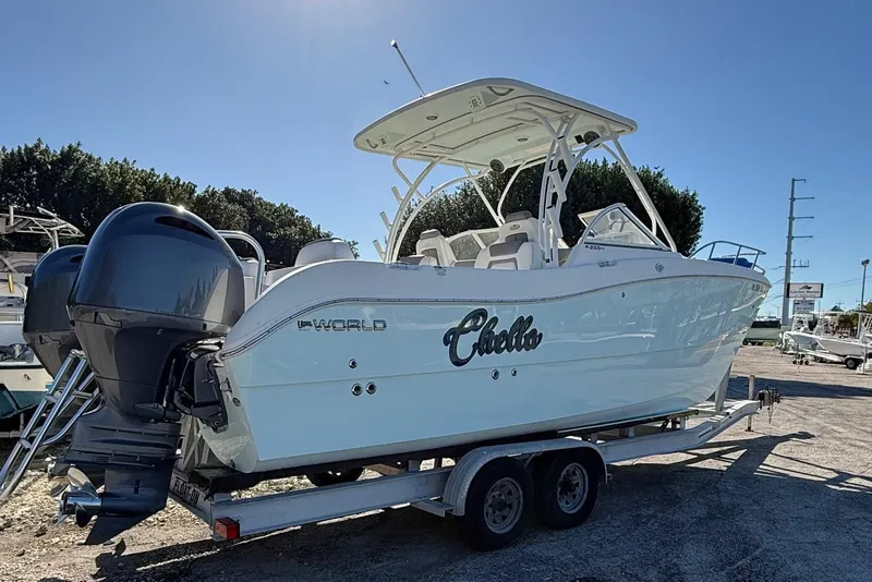 Slide: The Image of 2017 World Cat 255 DC boat on trailer, featuring dual engines and sleek design. - 1