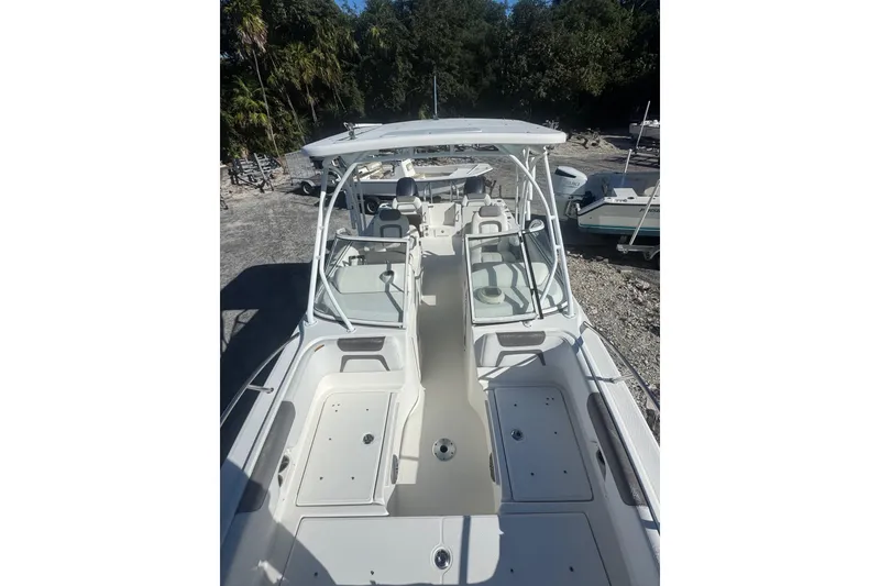 Slide: The Image of 2017 World Cat 255 DC boat with spacious deck and seating, docked outdoors. - 4