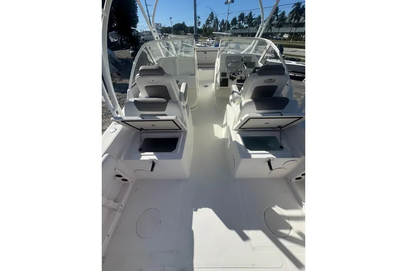 Slide: The Image of 2017 World Cat 255 DC boat interior with open storage compartments and seating. - 7