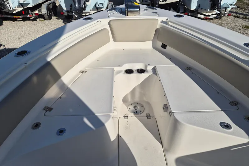 Slide: The Image of 2026 Key West 239 FS boat interior with storage compartments and cup holders. - 11