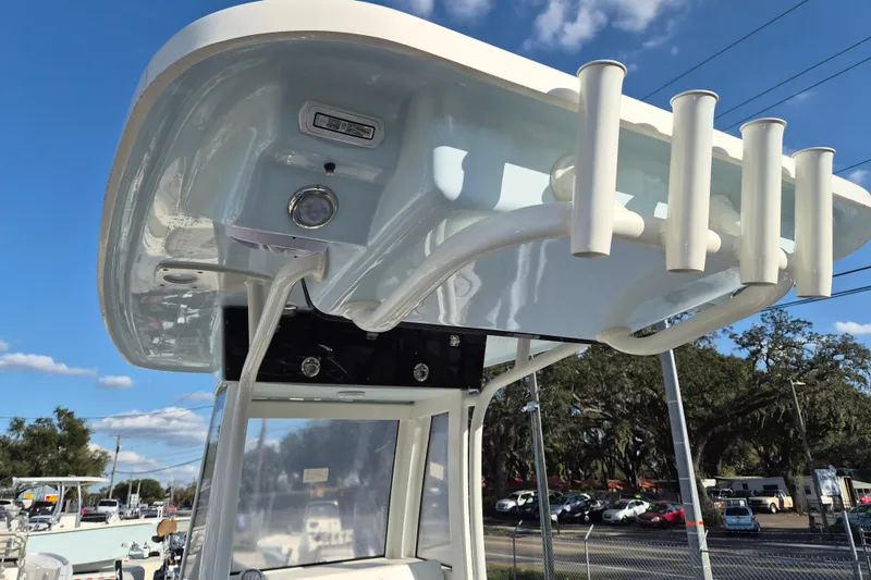 Slide: The Image of 2026 Key West 239 FS boat with rod holders and canopy, under a clear blue sky. - 13
