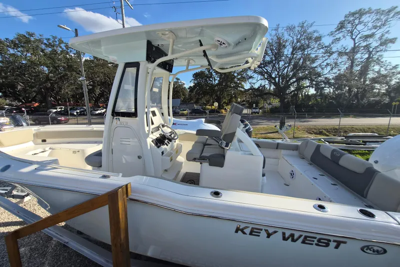 Slide: The Image of 2026 Key West 239 FS boat with sleek design and modern features, docked outdoors. - 14