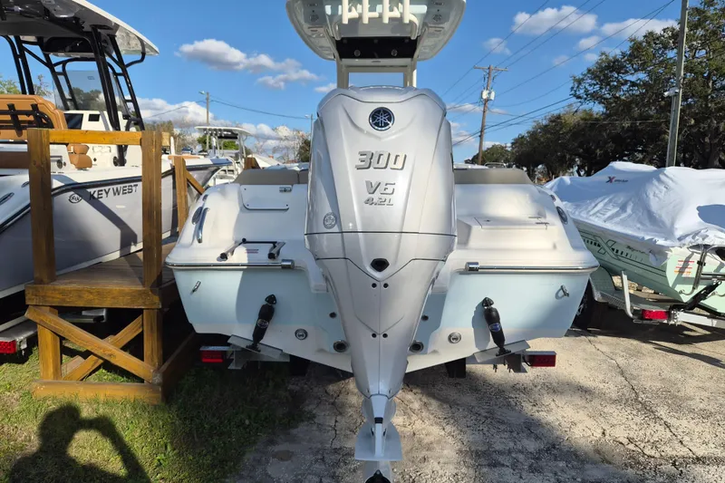 Slide: The Image of 2026 Key West 239 FS boat with Yamaha 300 V6 engine, parked outdoors. - 15