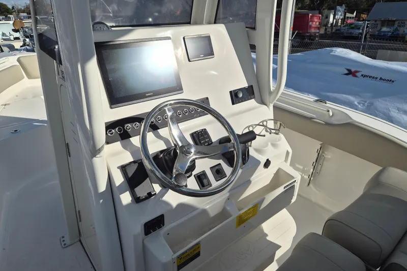 Slide: The Image of 2026 Key West 239 FS boat dashboard with steering wheel and navigation screens. - 4