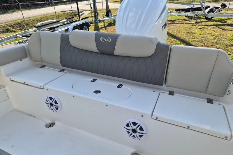 Slide: The Image of 2026 Key West 239 FS boat interior with cushioned seating and built-in speakers. - 5
