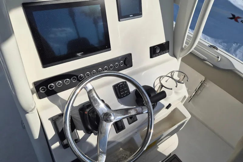 Slide: The Image of 2026 Key West 239 FS boat dashboard with steering wheel and navigation display. - 9