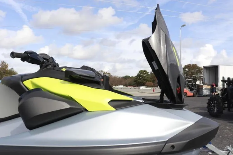 Slide: The Image of 2024 Sea-Doo RXP-X 325 jet ski with open storage compartment, showcasing sleek design. - 11
