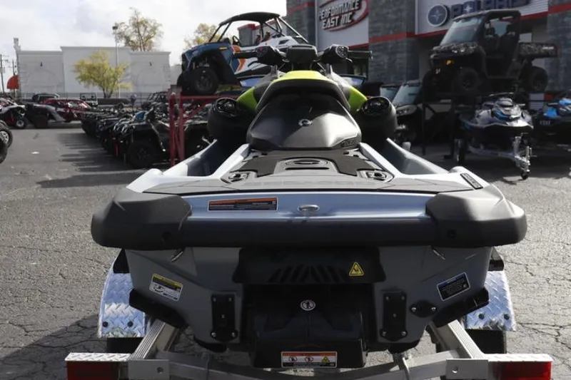 Slide: The Image of 2024 Sea-Doo RXP-X 325 jet ski displayed in outdoor showroom, rear view. - 14