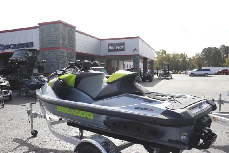 Slide: The Image of 2024 Sea-Doo RXP-X 325 jet ski on trailer at dealership. - 8