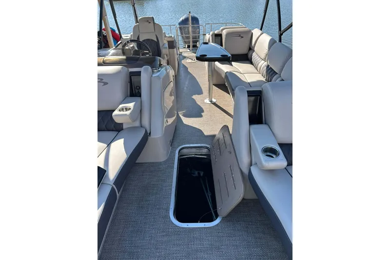 Slide: The Image of 2018 Bennington 25 QCW pontoon boat interior with open storage compartment. - 10