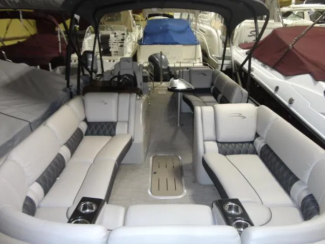 Slide: The Image of Interior view of a 2018 Bennington 25 QCW pontoon boat in dock. - 24