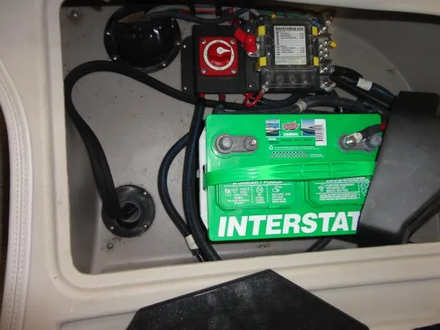 Slide: The Image of Battery compartment of 2018 Bennington 25 QCW with green Interstate battery. - 36