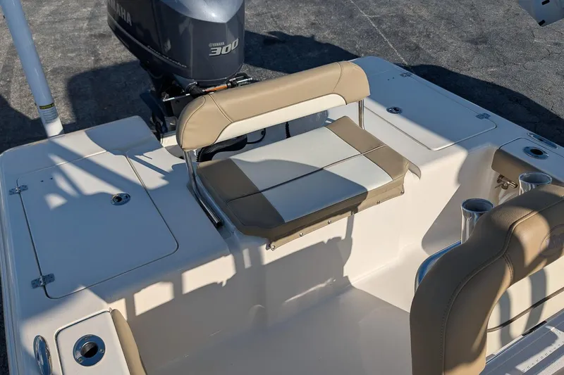 Slide: The Image of 2014 Key West 246 Bay Reef boat interior with Yamaha 300 engine, featuring beige seating. - 10