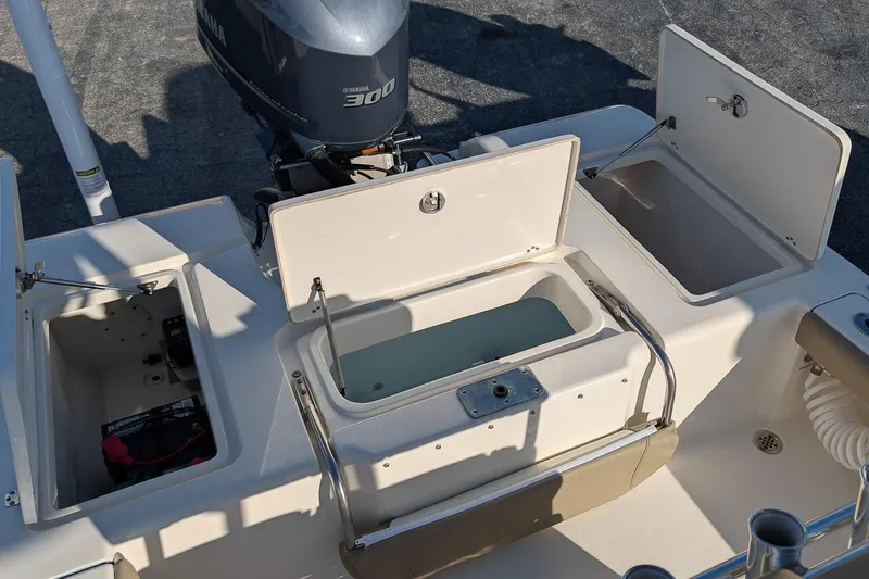 Slide: The Image of 2014 Key West 246 Bay Reef boat with open storage compartments and Yamaha 300 engine. - 11