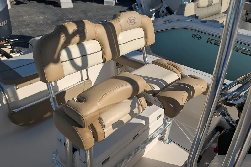 Slide: The Image of 2014 Key West 246 Bay Reef boat with beige seating and console details. - 13