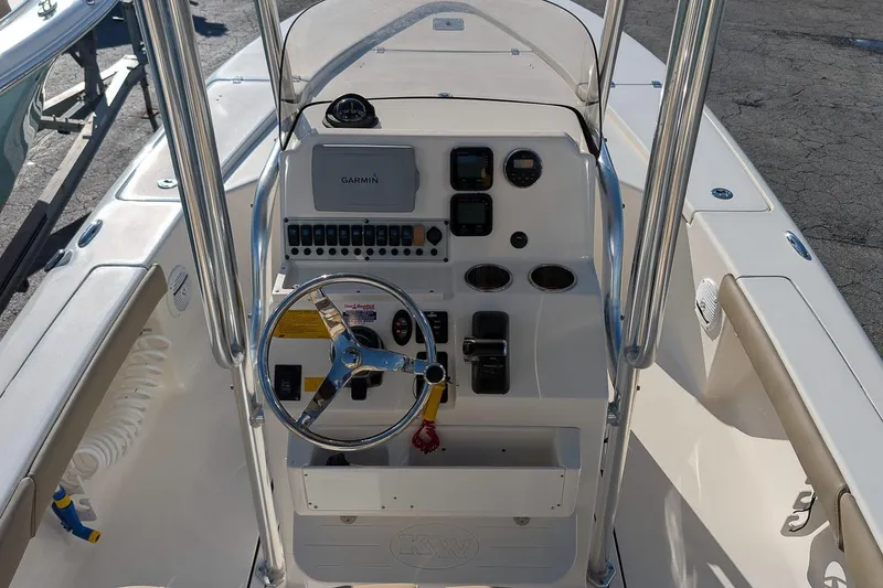 Slide: The Image of 2014 Key West 246 Bay Reef boat console with steering wheel and Garmin display. - 14