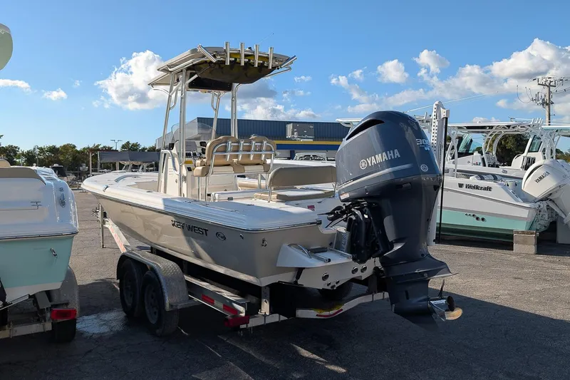 Slide: The Image of 2014 Key West 246 Bay Reef boat with Yamaha engine on trailer, sunny day. - 2