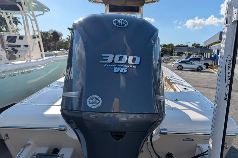 Slide: The Image of 2014 Key West 246 Bay Reef with Yamaha 300 V6 outboard engine in a marina setting. - 6