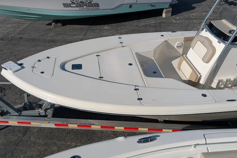 Slide: The Image of 2014 Key West 246 Bay Reef boat on trailer, featuring spacious deck and seating. - 9