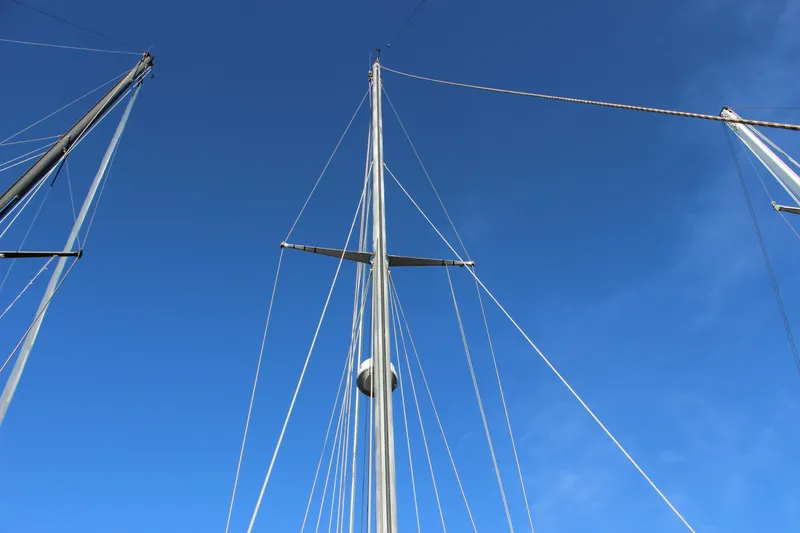 Slide: The Image of Masts of a 1973 Nautor Swan 44 sailboat against a clear blue sky. - 17