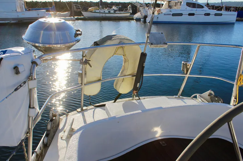 Slide: The Image of 1973 Nautor Swan 44 yacht deck with lifebuoy and marina view. - 18