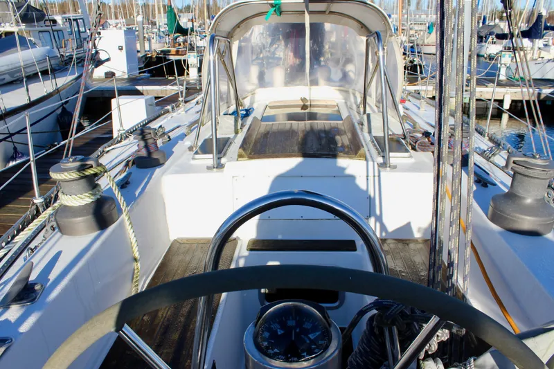 Slide: The Image of Cockpit view of a 1973 Nautor Swan 44 sailboat docked at a marina. - 19